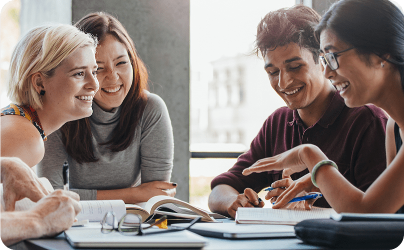 Group of people studying and smiling together.