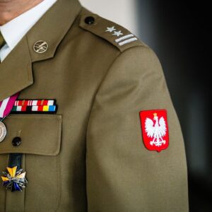 Polish military uniform sleeve with emblem and medals.