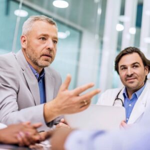 Doctors discussing patient care in a medical meeting.