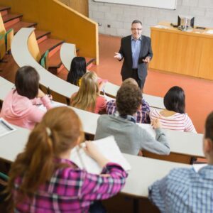 Professor teaching students in a university lecture hall.